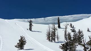 snowmobile jumping off big cornice