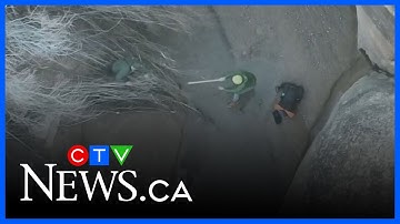 Drone video shows recue of hiker stuck in quicksand