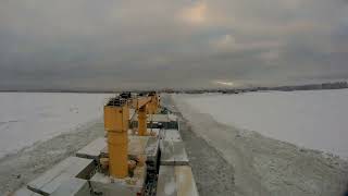 Entrance to port of Saint-Petersburg in winter time. Cargo vessel.