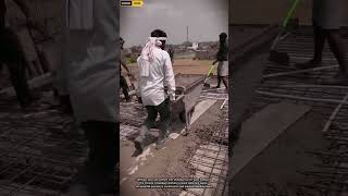 Workers Pouring Cement into Wheelbarrow for Efficient Construction Material Transport