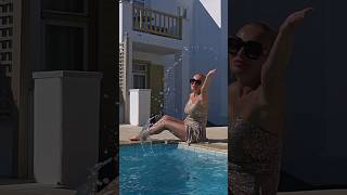 woman spends a sunny day by the pool, Mykonos Greece 2023 keycath legsday