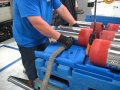 Demonstrating lifting strap method in stratis pallet