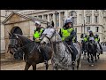 Police and horses in riot gear as the kings guard is removed when a protest passes horse guards