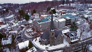 Old Ellicott City dusk in the snow drone flight 1.18.2024