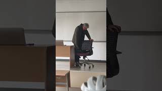 Caring Professor Pets a Cat Occupying His Seat