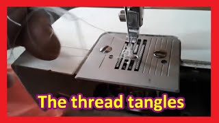 Why does the domestic sewing machine THREAD GET TANGLED UNDERNEATH