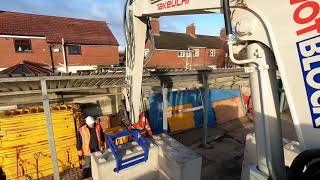 Wotblock installing concrete interlocking Lego blocks.