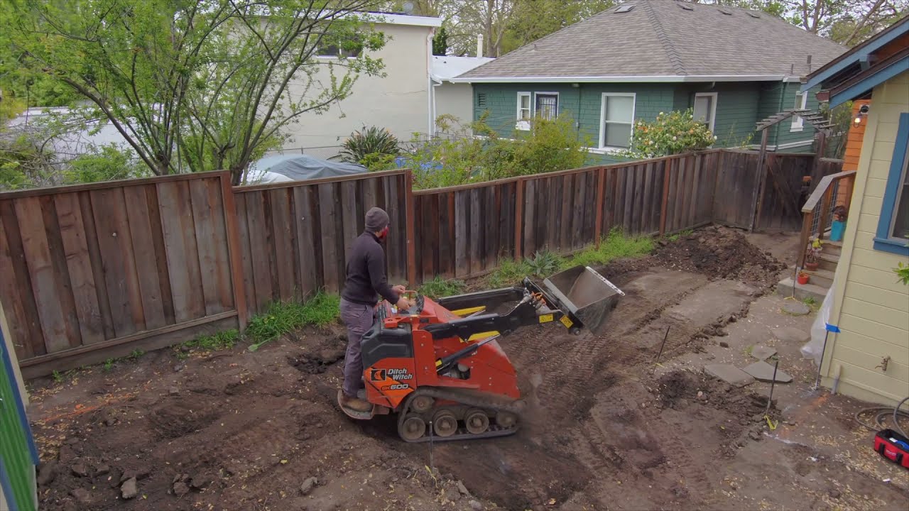 Using a Mini Skid Steer to Grade a New Patio