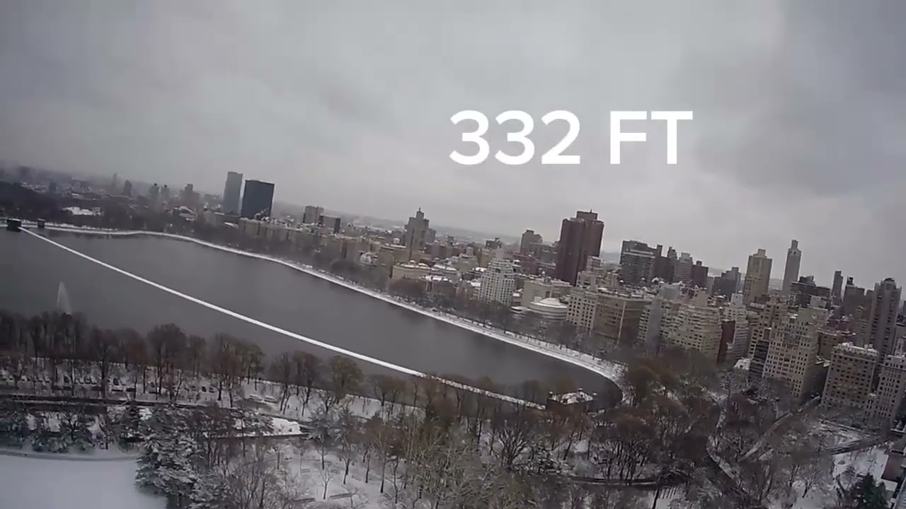 Drone flying over Central Park when it is snowing