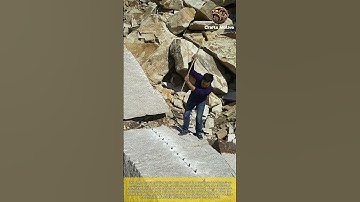 Splitting rocks with wedges: craftsman using a sledgehammer to open and hit the rock