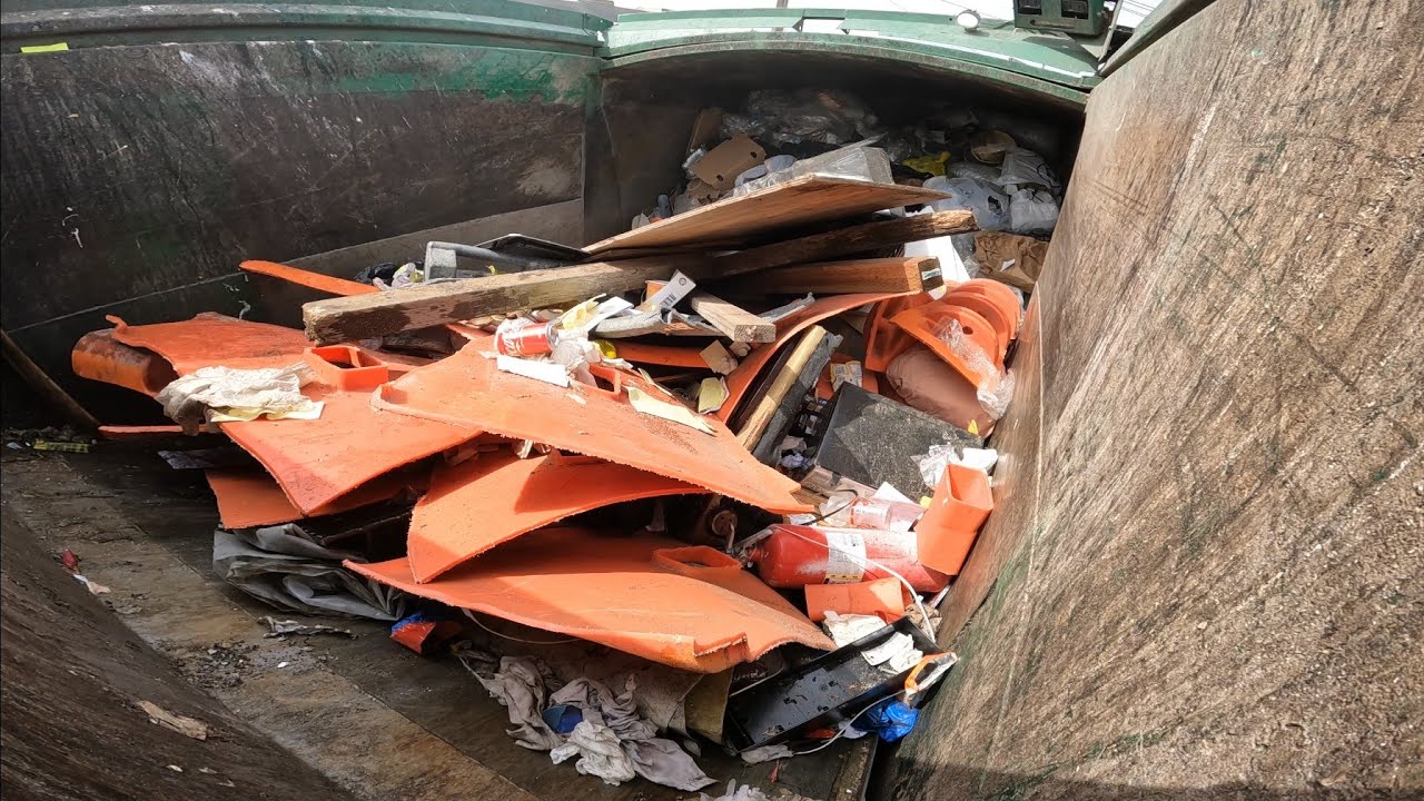 Waste Management garbage truck smashing garbage 