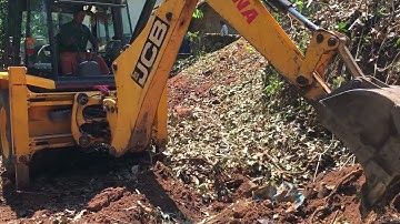 Jcb 3dx digging out roots of trees and levelling soil