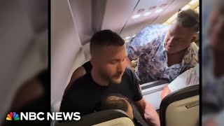 Passengers restrain man accused of trying to enter Frontier airlines cockpit mid-flight