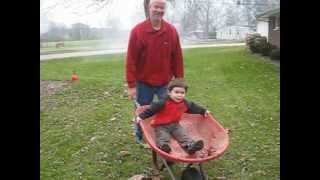 Tom pushing wheelbarrow with Jordan in it !