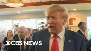 Trump stops at cafe and greets supporters after federal arraignment