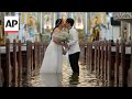 Couple marries in flooded Philippines church after Typhoon Wipha intensifies rains