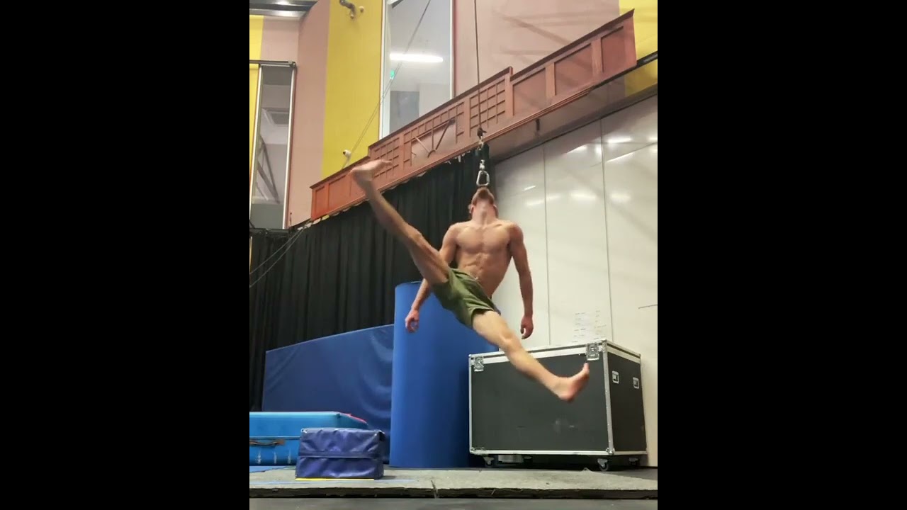 Circus Artist Hangs on Cable By His Mouth - 1283756