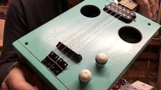 baby blue 4 string cigar box guitar