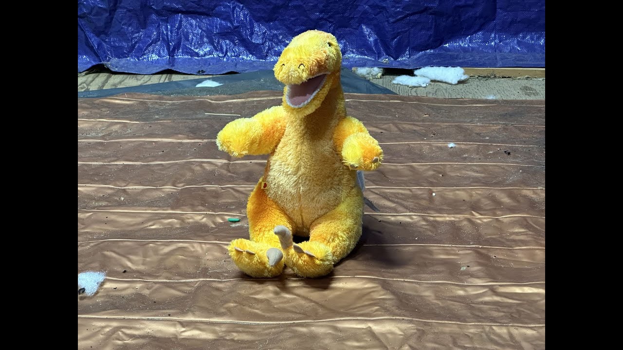 destroy-stuffed-animal-build-a-bear-orange-raptor-pulling-it-apart