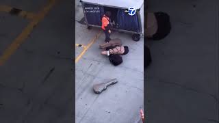Baggage handler at LAX carelessly tosses guitars on tarmac