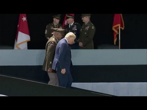 Trump appears to steady himself walking down West Point ramp