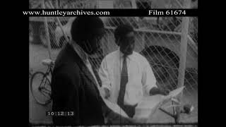 Two black men reading newspaper.  Archive film 61674
