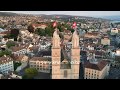 Aerial Drone Shot Flying Backwards Between The Two Towers Of Grossmunster in Zurich, Switzerland