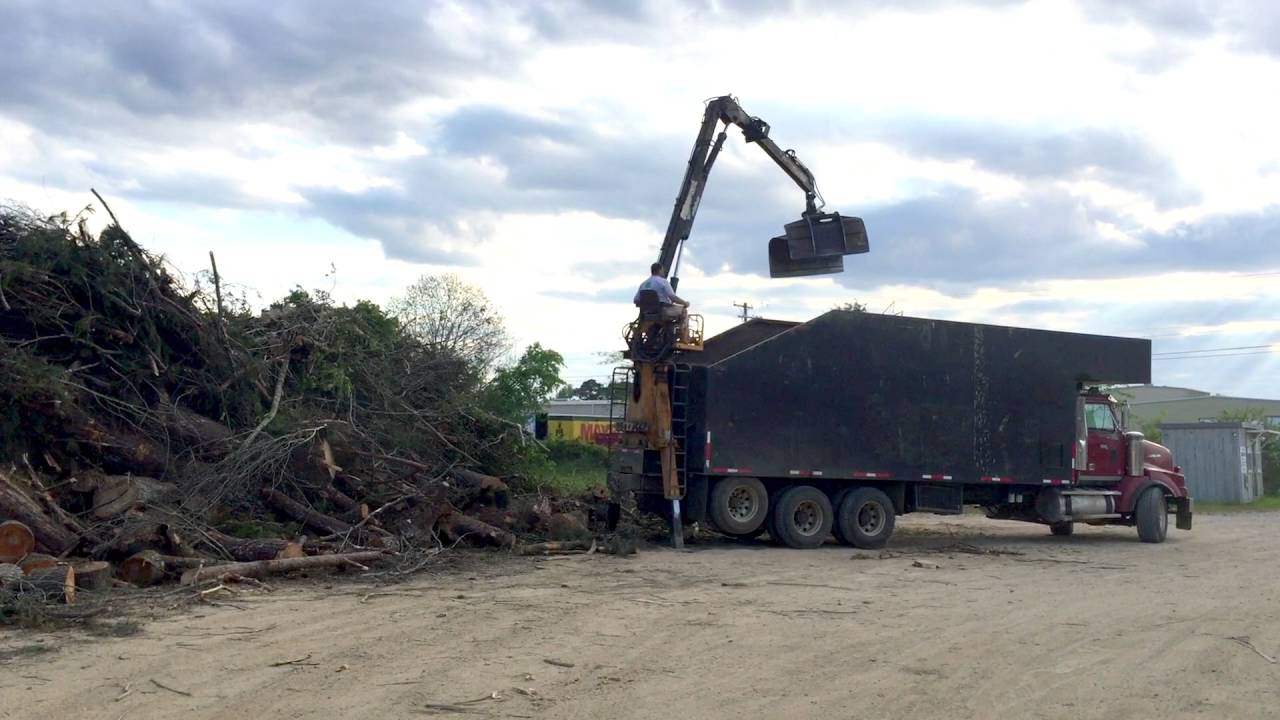 Unloading Brush from Rear Mount Grapple Truck - YouTube