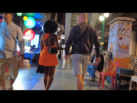 A white man holding hands with a beautiful black woman. Bangkok Sukhumvit Road