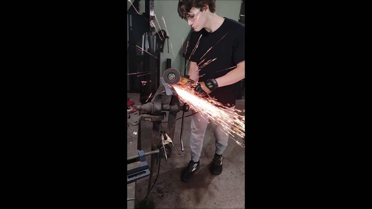 Jett, making his first Damascus knife at LLForge "From Billet to Blade" knife-making experience.