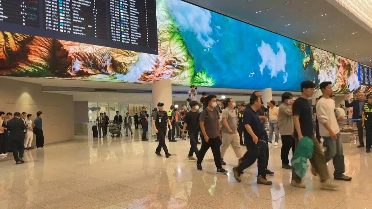 South Korean workers arrive home after US detention | AFP