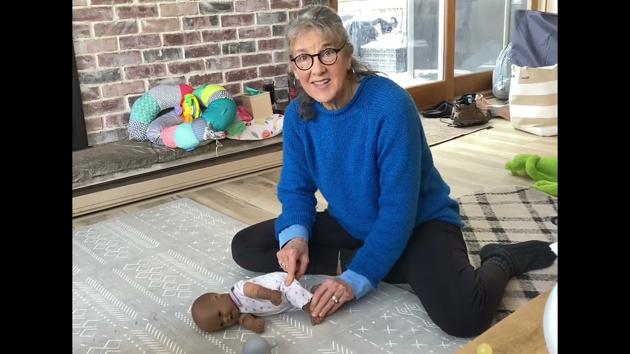 Child’Space demo on a doll for a baby beginning to roll and encouraging side lying. ￼