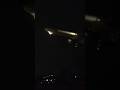 Iconic Boeing 777-300er landing at airport at night.