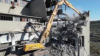 Excavator crasher machine at demolition on construction