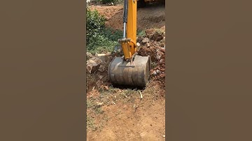 JCB 2DX digging small holes for coconut tree plantation