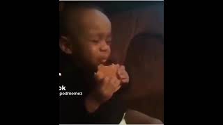 Little kid eating hamburger and crying