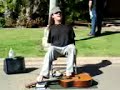 Man with no arms playing freebird on guitar