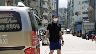 A man walking towards the camera then a taxi drove by him (4K)