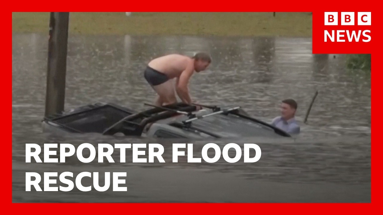 Reporter swims through flood to rescue man from sinking car | BBC News