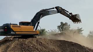 A very big HITACHI excavator working with a professional controller