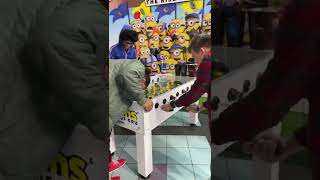 Pablo, Cody & Caleb playing minions: rise of Gru foosball @ Regal @ Winter park village