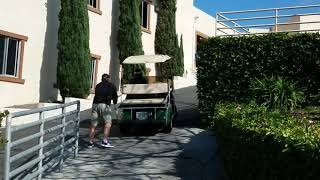 Pushing a golf cart uphill