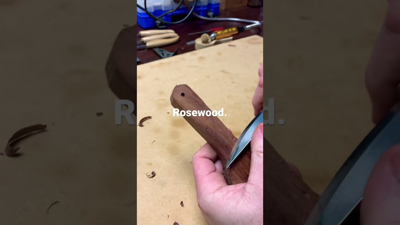 Carving a rosewood coffee scoop. 