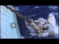 Anchor being pulled up a ship underway in the Pacific Ocean during World War II. HD Stock Footage