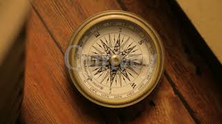Fast-moving dial of Compass on wooden base historic medieval-looking object | Stock Video | Qonvey screenshot 4