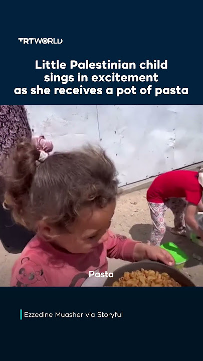 Little Palestinian child sings in excitement as she receives a pot of pasta