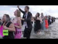 USA: See fancy-dressed beachgoers get all wet in NYC