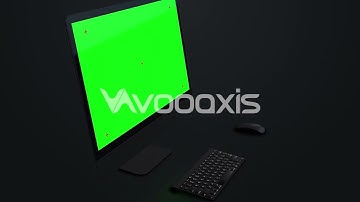 Desktop computer with green screen mock up in dark background