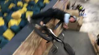 BMX rider attempts backflip up ramp into foam pit but lands on the corner