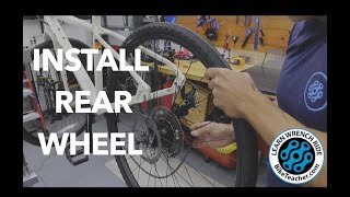 How to install a rear wheel with a derailleur.